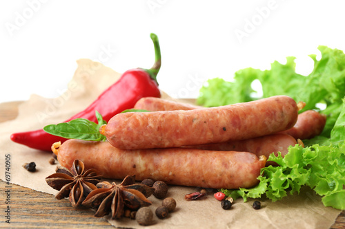 Smoked thin sausages  with lettuce salad leaves and spices