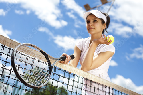 Female playing tennis on court 