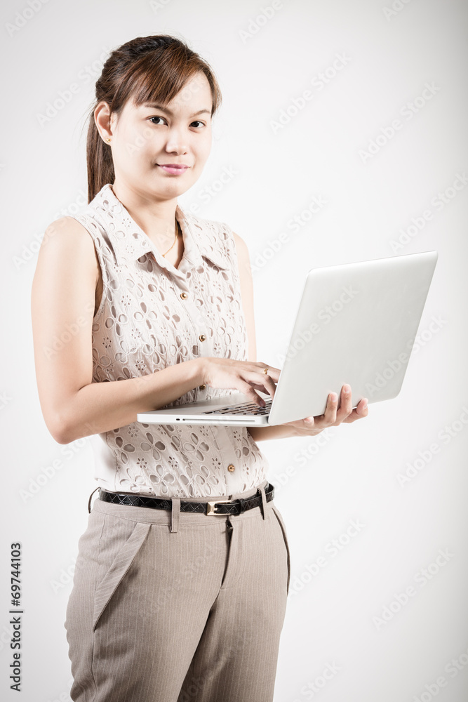 Happy young woman using her laptop Happy young woman using her laptop