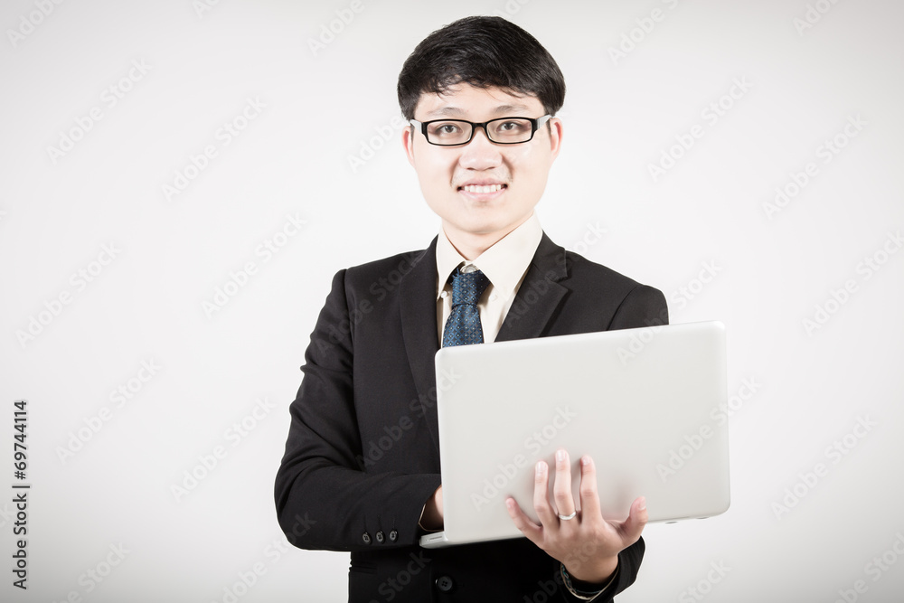 Asian business man using laptop computer isolated on white backg Asian business man using laptop computer isolated on white backg