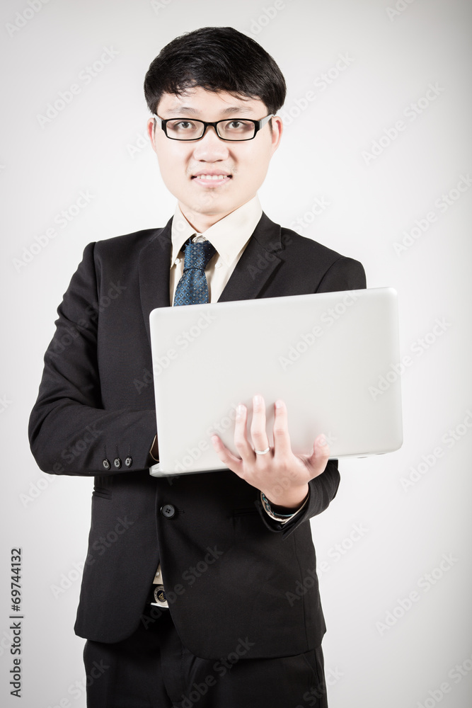 Asian business man using laptop computer isolated on white backg Asian business man using laptop computer isolated on white backg