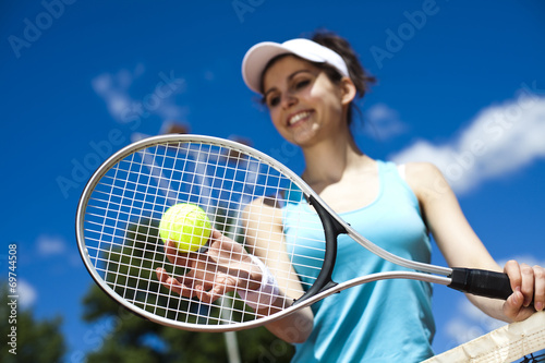 Female playing tennis on court  © Sebastian Duda