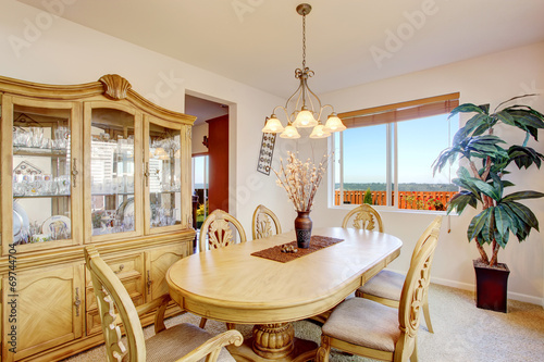 Beautiful carved wood dining table set in bright room photo