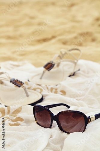 Sunglasses sarong sandals on the beach