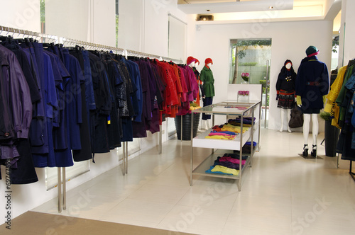 Designer clothes lined up in store
