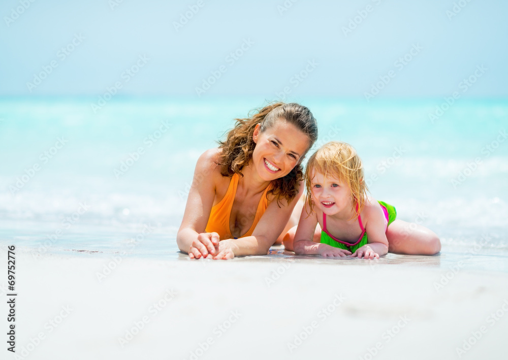 Portrait of mother and baby girl relaxing on sea coast Portrait of mother and baby girl relaxing on sea coast