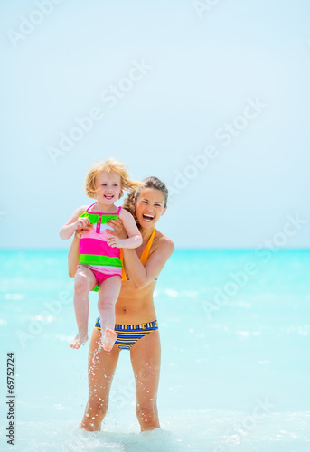 Portrait of mother and baby girl in sea