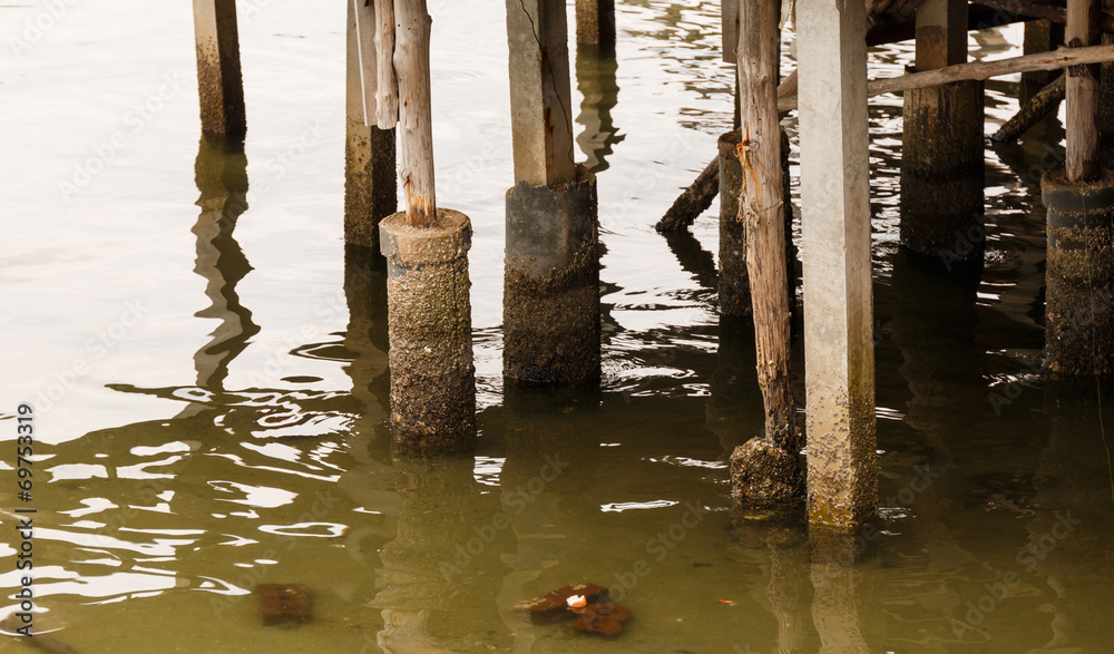 Old wooden posts in the shallow sea Old wooden posts in the shallow sea