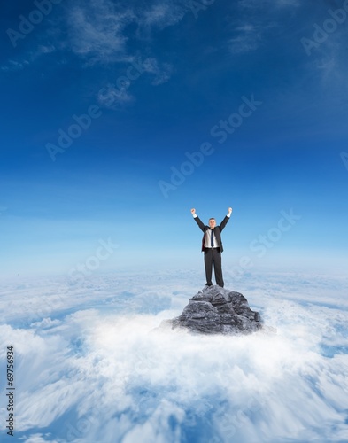 Composite image of mature businessman cheering with arms up