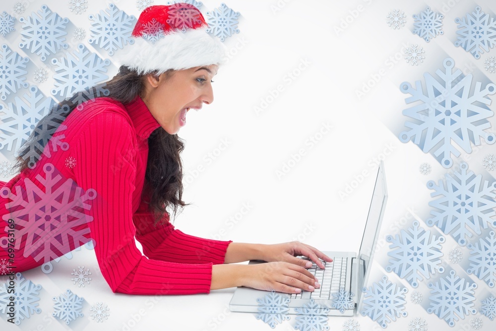 Composite image of beautiful festive woman typing on laptop Composite image of beautiful festive woman typing on laptop