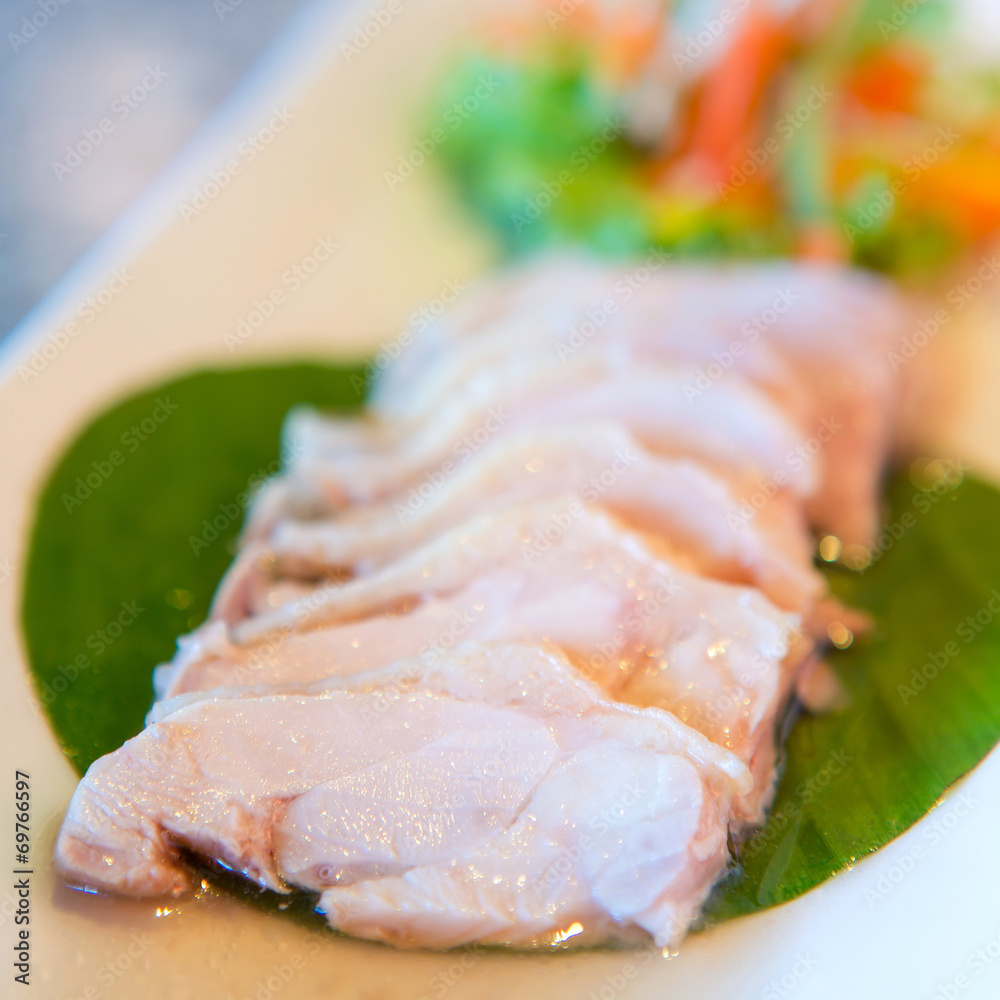 Sliced chicken breast fillet on a cutting board Sliced chicken breast fillet on a cutting board
