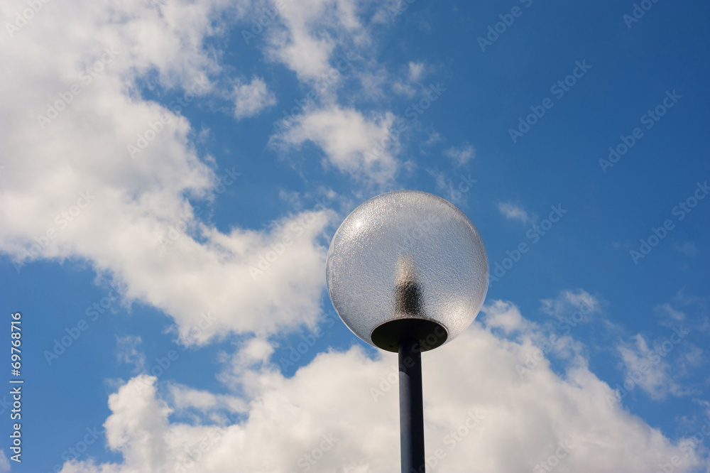 modern spherical lamppost in front of a cloudy sky modern spherical lamppost in front of a cloudy sky