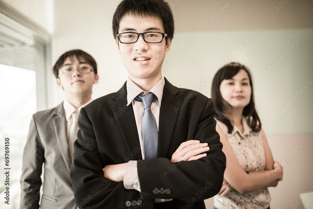 Happy business team with arms crossed at the office Happy business team with arms crossed at the office