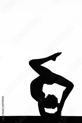 women contortionist practicing gymnastic yoga in silhouette