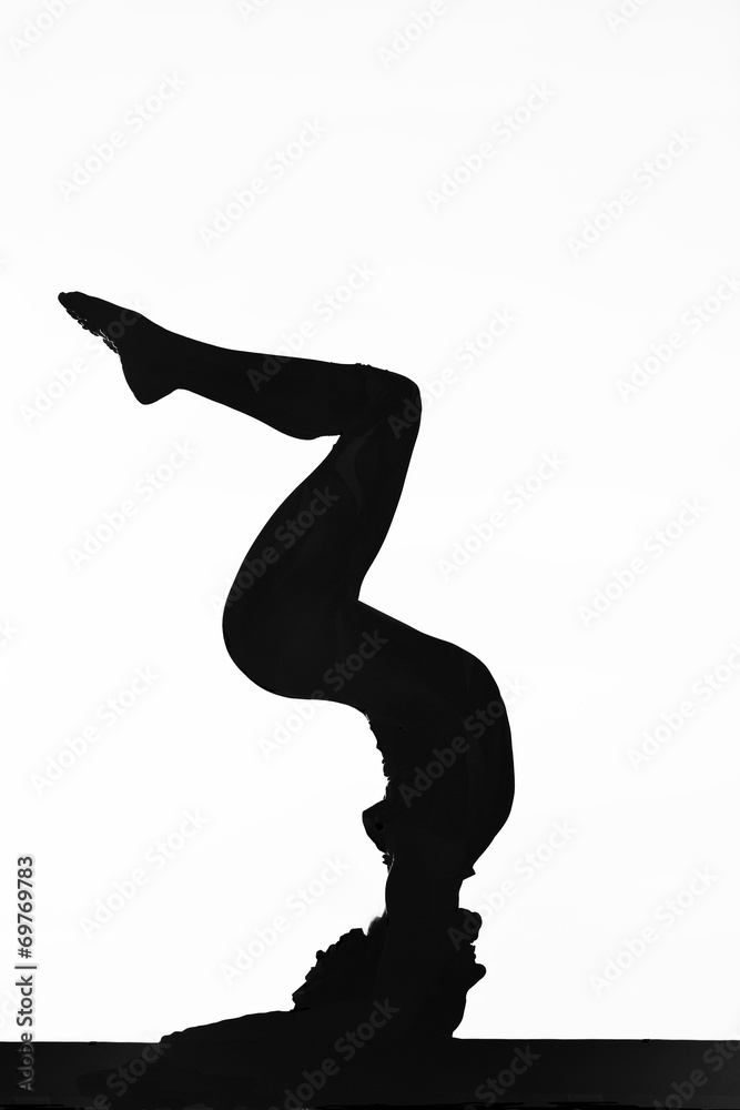 women contortionist practicing gymnastic yoga in silhouette women contortionist practicing gymnastic yoga in silhouette
