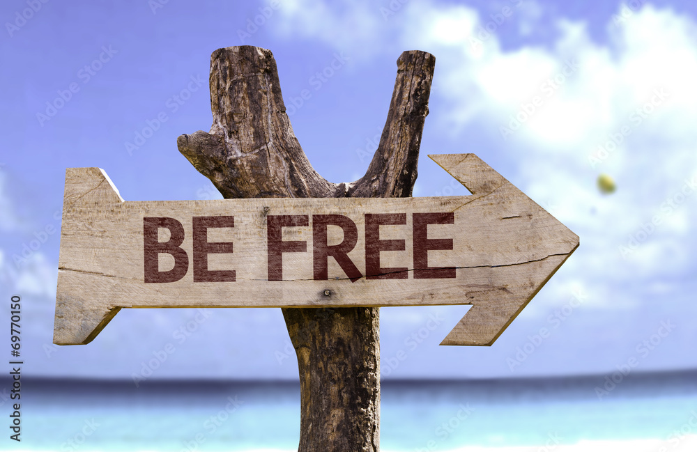 Be Free sign with a beach on background