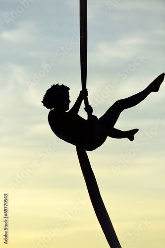woman acrobatic dancer on aerial silk, aerial contortion