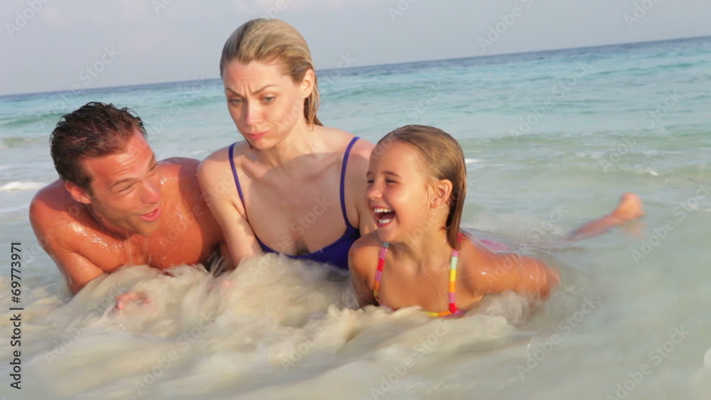 Family Relaxing On Tropical Beach Family Relaxing On Tropical Beach