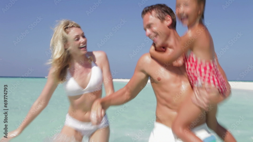 Family Having Fun In Sea On Beach Holiday Family Having Fun In Sea On Beach Holiday