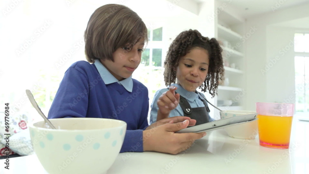 African American Children Use Digital Tablet Over Breakfast African American Children Use Digital Tablet Over Breakfast