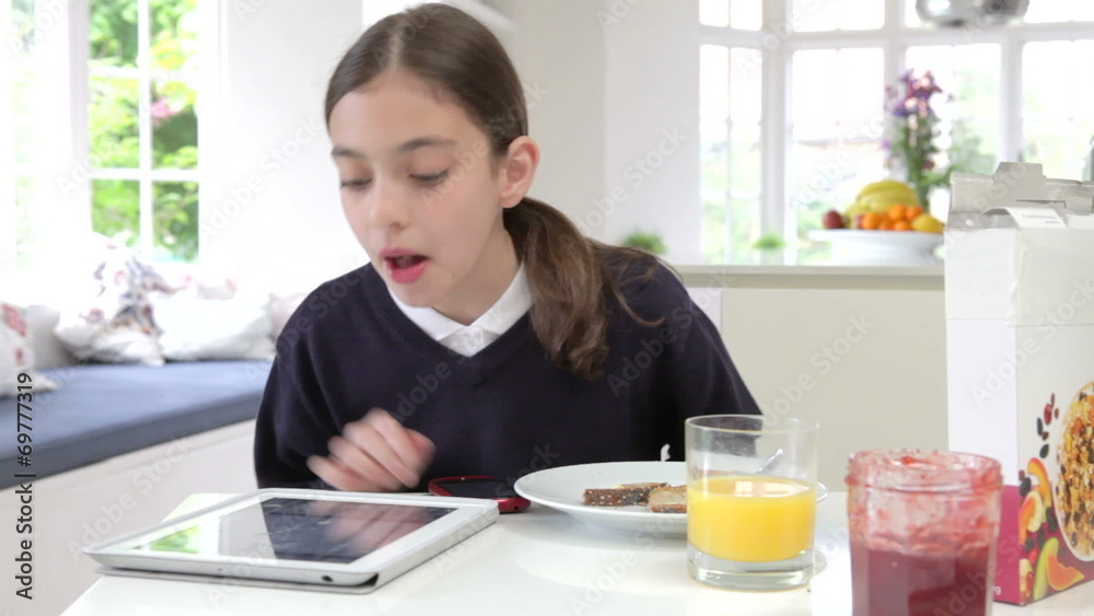 Schoolgirl With Digital Tablet And Mobile Drinking Juice Schoolgirl With Digital Tablet And Mobile Drinking Juice
