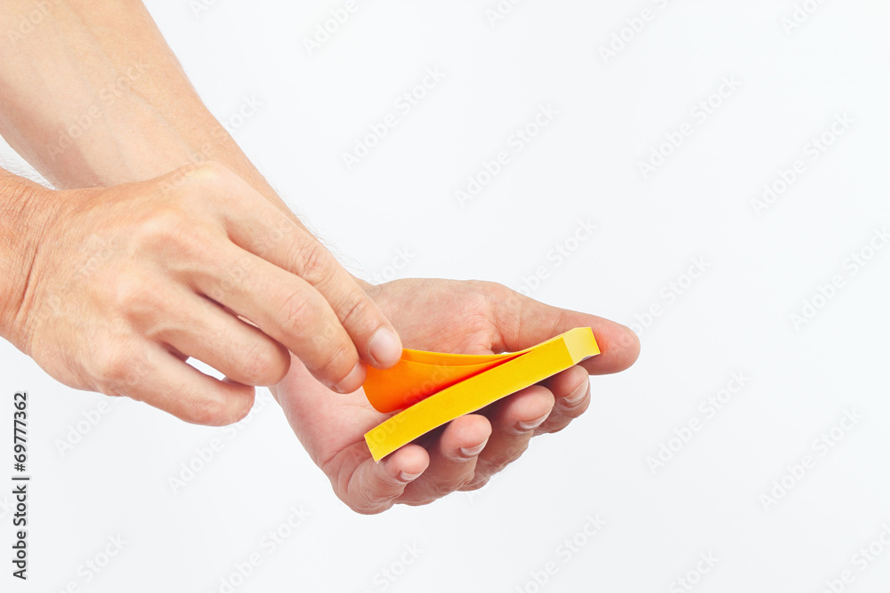 Hand with orange stickers on a white background Hand with orange stickers on a white background
