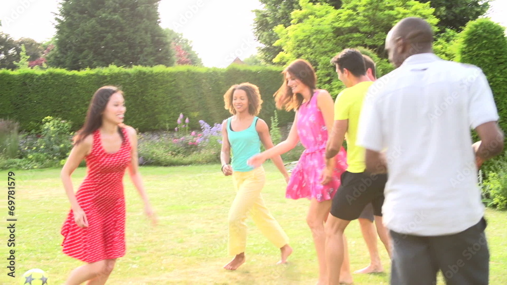 Slow Motion Sequence Of Friends Playing Football In Garden Slow Motion Sequence Of Friends Playing Football In Garden