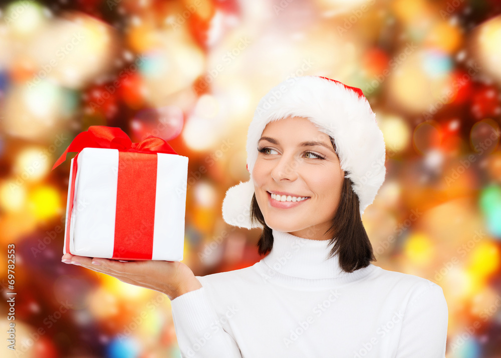 smiling woman in santa helper hat with gift box smiling woman in santa helper hat with gift box