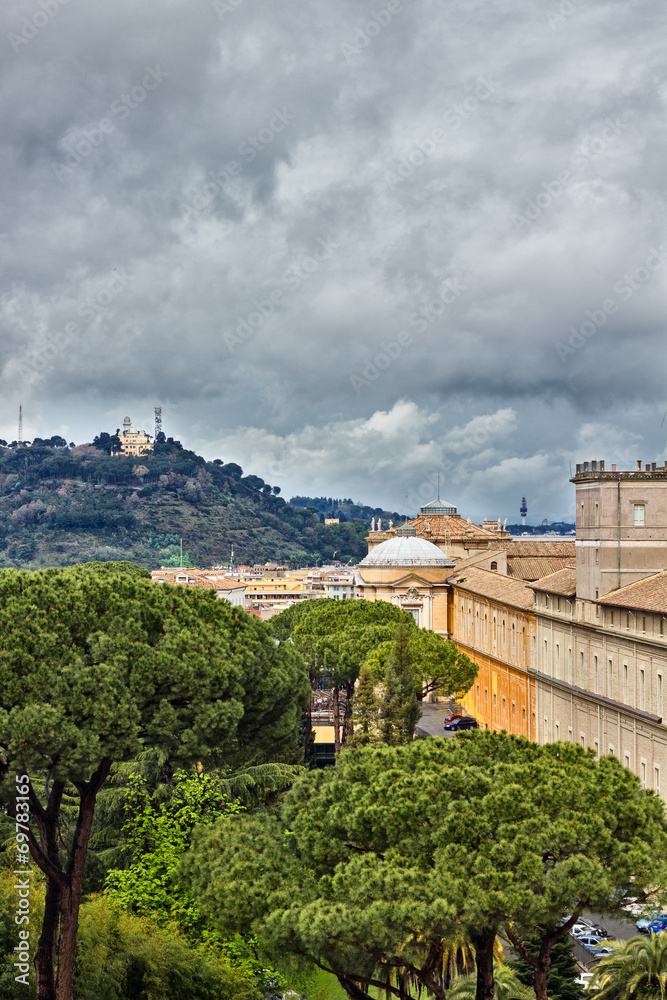 Rome hills and buildings against dark clouds