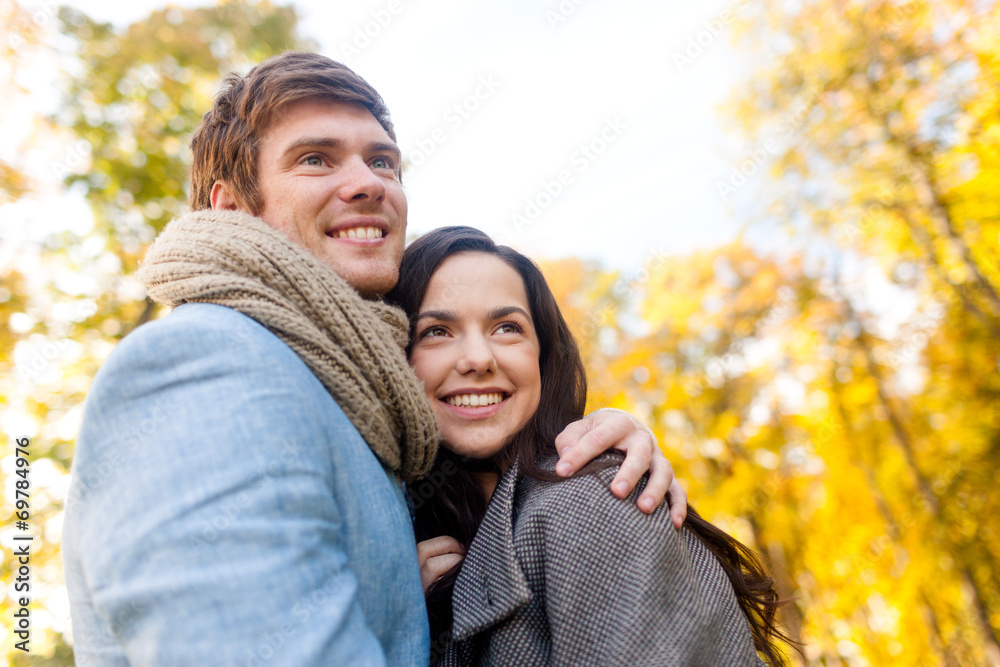 smiling couple hugging in autumn park smiling couple hugging in autumn park