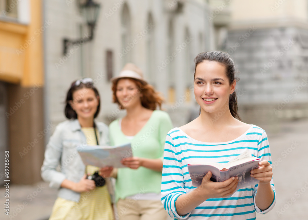 smiling teenage girls with city guides and camera smiling teenage girls with city guides and camera