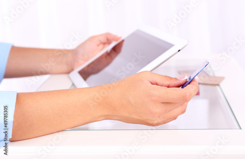 Woman using digital tablet and holding credit card in her hand,