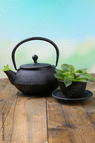 Chinese traditional teapot with fresh mint leaves