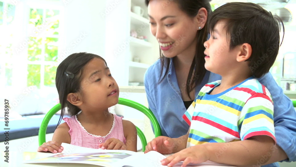 Asian Mother Reading A Story To Children Asian Mother Reading A Story To Children