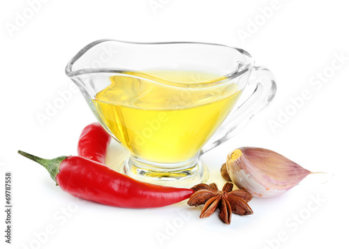 Homemade natural infused olive oil in glass sauce-boat with red