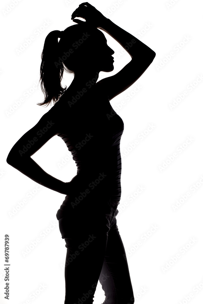 silhouette of a young pretty woman posing on white