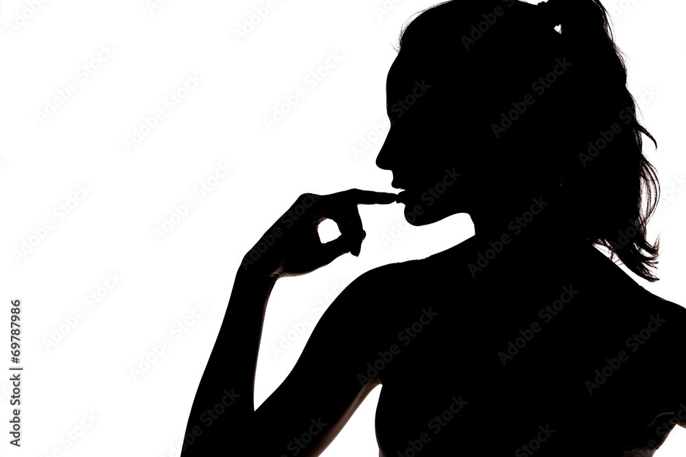silhouette - sensual portrait of a woman touching her lips