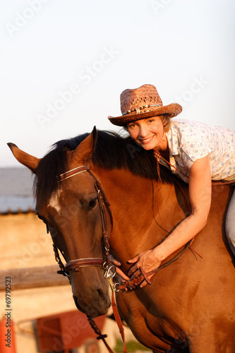 Woman on brown horse © PaulShlykov