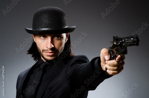 Man with gun and vintage hat