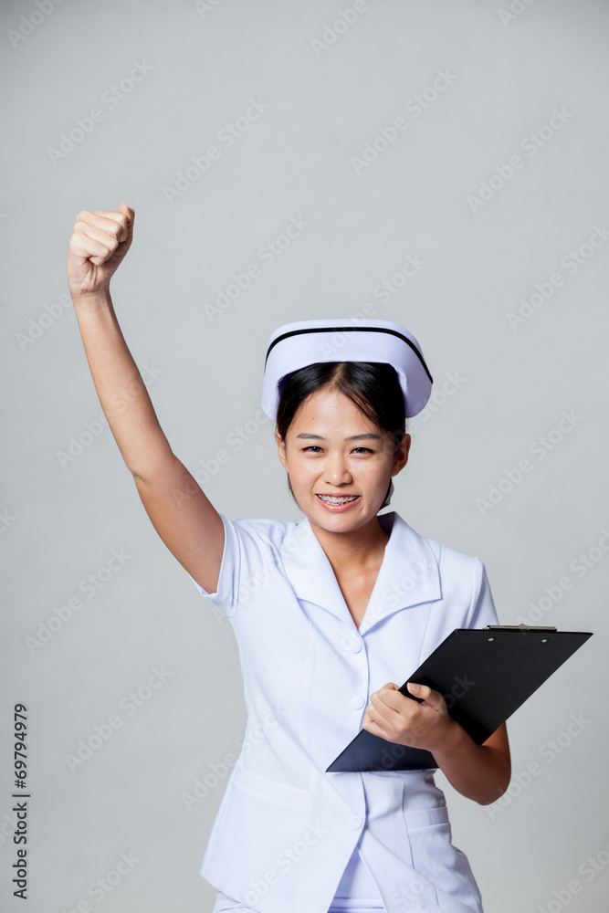 Young Asian nurse fist pump with success Young Asian nurse fist pump with success