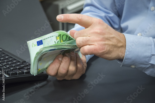 Close-up of bank clerk counting euros