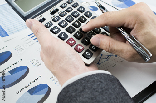 man hand with pen and business report. Accounting