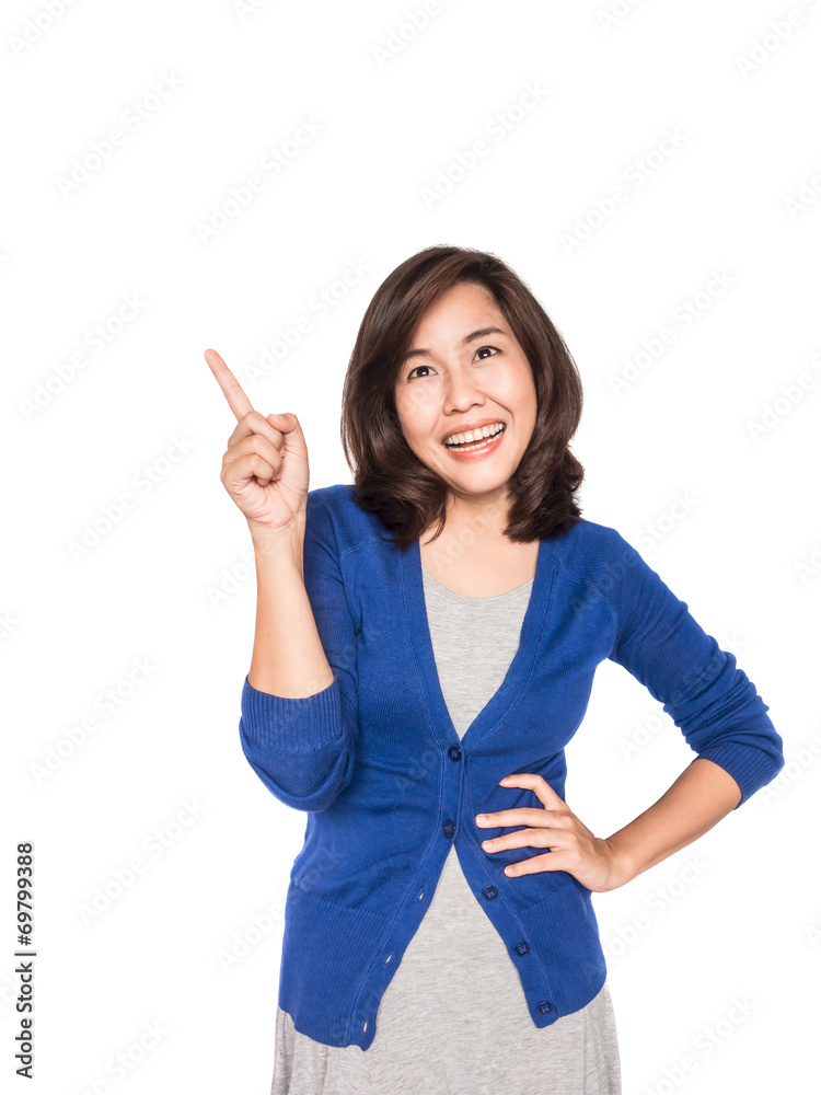 Woman smiling pointing up showing copy space. Woman smiling pointing up showing copy space.