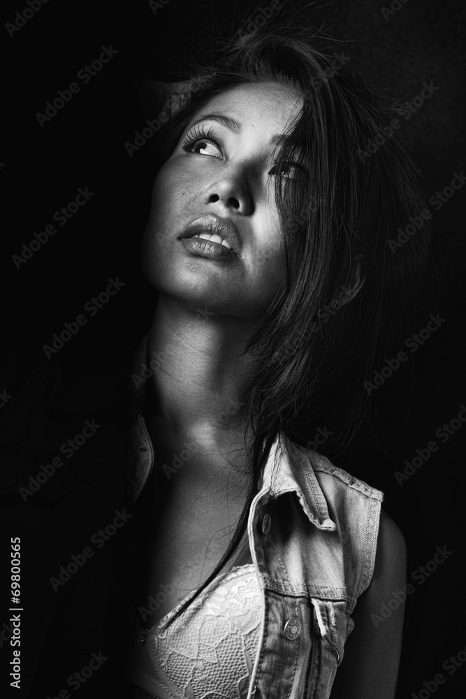 Portrait of the sensual girl in jeans jacket on the black