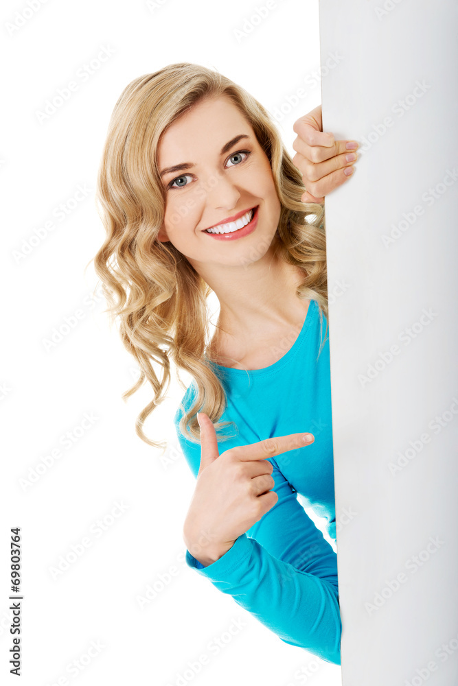 Portrait of happy woman with blank board