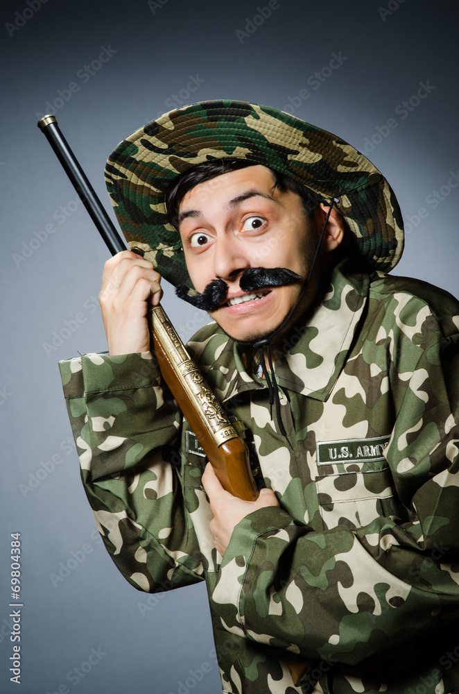 Funny soldier against the dark background Funny soldier against the dark background