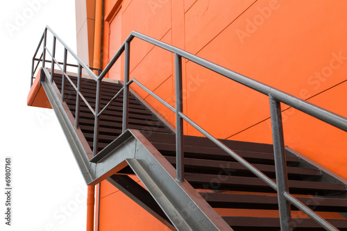 фотографія Metal fire escape or emergency exit on Orange Wall of Buliding W