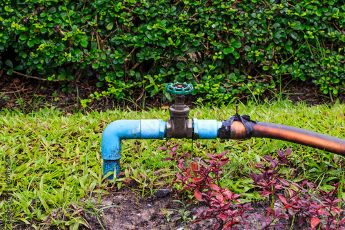 Old Valve with Rubber Tube in Garden..