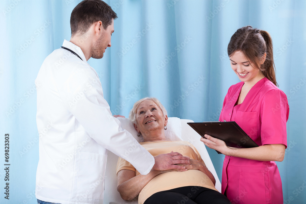 Fototapeta premium Young doctors talking with patient