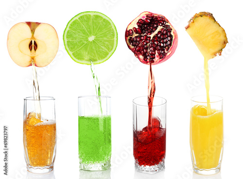 Juice pouring from fruits into glass, isolated on white